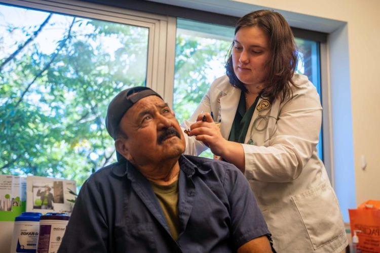 a patient is fitted for a hearing aid